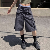 Workwear style with multiple pockets, cuffed and tied up half length pants, loose and casual low waisted straight woven shorts HGMFP05265